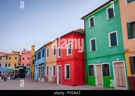 Burano, Italy - October 2018: Locals mingle around the colorful houses in Burano Stock Photo