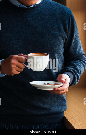 Coffee time. Cropped image of handsome young man enjoying coffee Stock Photo
