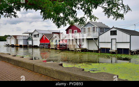 Wooden boat houses (Aquaholicks) along City Pier, Canandaigua Lake, one of the Finger Lakes, NY, USA Stock Photo