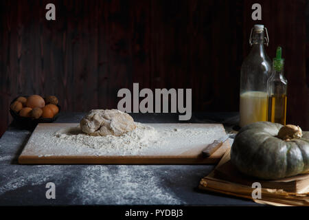 Baking Ingredients Eggs Pumpkin Butter Milk Nuts Flour On A Wooden Table Against A Dark Background Cope space Stock Photo