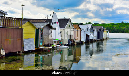 Wooden boat houses (Aquaholicks) along City Pier, Canandaigua Lake, one of the Finger Lakes, NY, USA Stock Photo