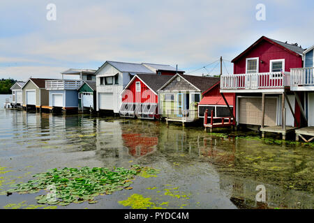 Wooden boat houses (Aquaholicks) along City Pier, Canandaigua Lake, one of the Finger Lakes, NY, USA Stock Photo