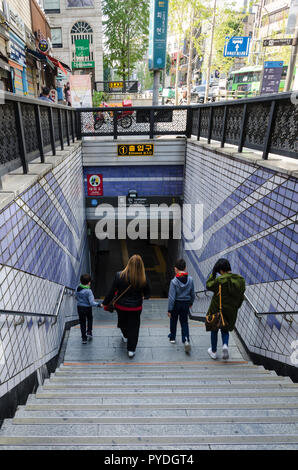People walk down steps into the Hoehyeon Subway Station in Seoul, South Korea. Stock Photo