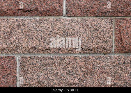 Red wall made of tiles. Beautiful warm colors including red, orange, brown, black and grey. Horizontal lines and very sharp details can be seen. Stock Photo