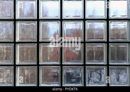 View through a window made of multiple transparent glass squares. Between those symmetric squares is back supportive structures. Stock Photo
