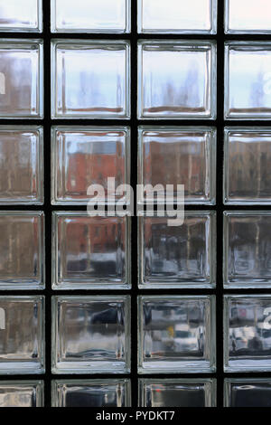 View through a window made of multiple transparent glass squares. Between those symmetric squares is back supportive structures. Stock Photo