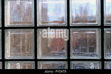 View through a window made of multiple transparent glass squares. Between those symmetric squares is back supportive structures. Stock Photo