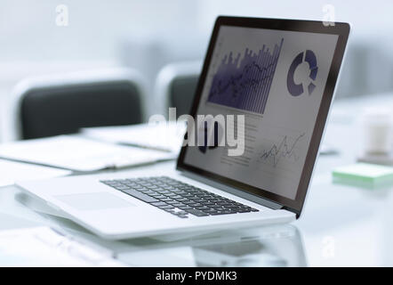 close up.laptop with financial data on screen on blurred office background Stock Photo