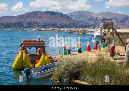 The Uros floating islands in lake Titicaca, Peru. Tipical boat and natives Stock Photo