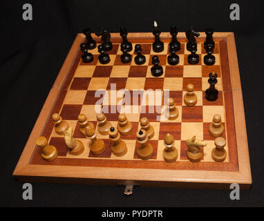 Abstract composition of chess figures. Isolated on black background, mat in two turns. Stock Photo