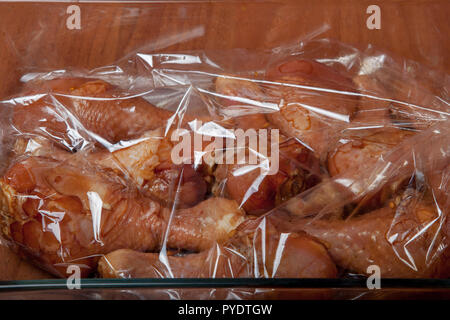 Chicken legs before baking in a baking sack Stock Photo