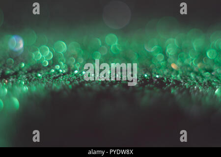 Green abstract bokeh on black background. Defocused. Free space for text. Abstract festive and holidays backgrounds for your design Stock Photo