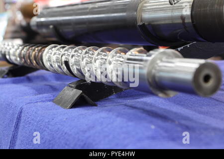 Screw press parts for plastic injection machine ; selective focus Stock Photo