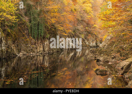 Autumn colours reflected in the River Garry, Killiecrankie Gorge, Perthshire, Scotland.