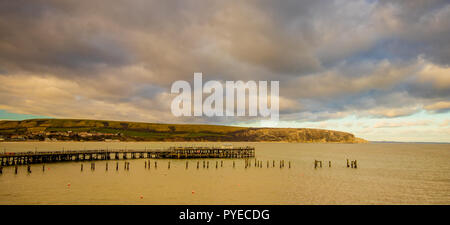 View across the piers in Swanage Bay towards Ballard Down, Dorset, UK Stock Photo
