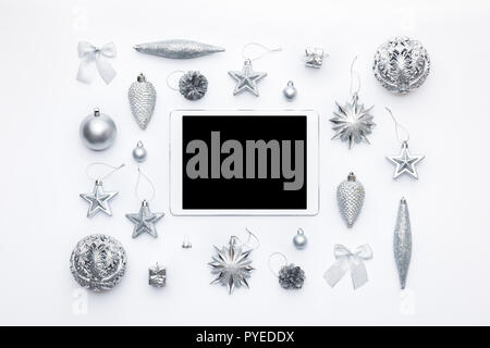 Online Christmas Shopping. Boxing Day Sale Background. Christmas ornaments and blank screen digital tablet isolated over white background. Stock Photo