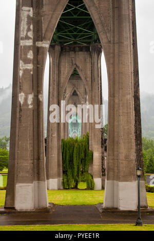 View southwest underneath the St. Johns Bridge and across Cathedral Park in Portland, Oregon, United States Stock Photo