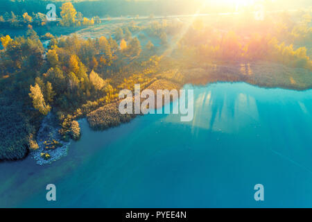 Beautiful aerial view at the island with colorful trees in autumn. Picturesque coastline at sunset Stock Photo