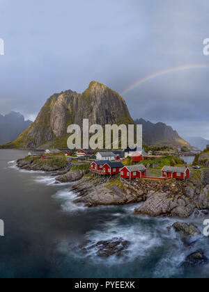 Rainbow over Hamnoy fishing village nestled into Norwegian fjords - Lofoten Stock Photo