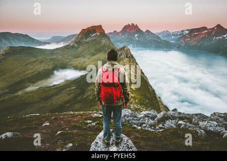 Hiker man exploring sunset mountains with backpack Traveling heathy lifestyle adventure concept hiking alone active summer vacations outdoor journey i Stock Photo