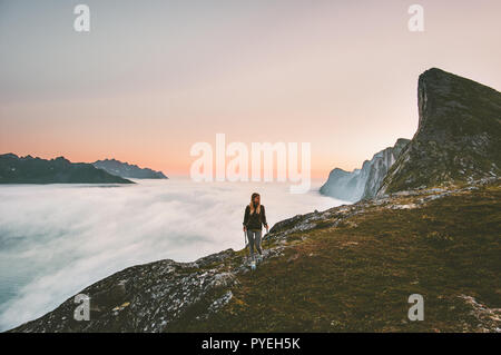 Active woman hiking in mountains outdoor active vacations traveling alone adventure healthy lifestyle girl trail running above clouds on ridge Stock Photo