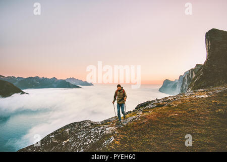 Active man trail running in sunset mountains with backpack Traveling heathy lifestyle adventure concept hiking alone vacations outdoor journey in Norw Stock Photo