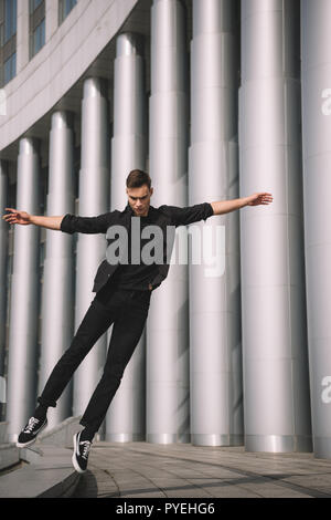 young contemporary dancer jumping in dance on street Stock Photo
