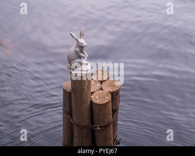 The sculptural figure of a hare on wooden stilts as a symbol of the Peter and Paul Fortress near the bridge in the city of St. Petersburg Stock Photo