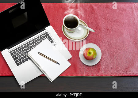 Notepad and notebook laptop on Red leather tablecloth, view from above Stock Photo