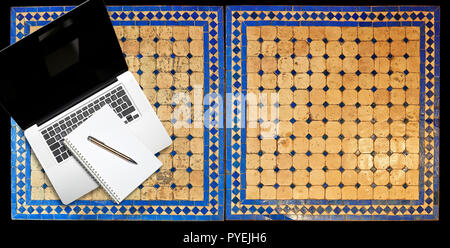 Notepad and notebook laptop on Two moroccan mosaic table, view from above Stock Photo