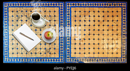 Notepad on Two moroccan mosaic table, view from above Stock Photo