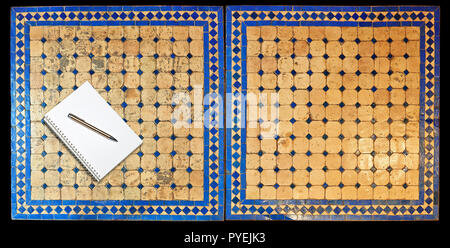 Notepad on Two moroccan mosaic table, view from above Stock Photo