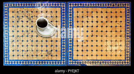 Cup of coffee on Two moroccan mosaic table, view from above Stock Photo