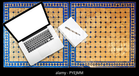 Notepad and notebook laptop on Two moroccan mosaic table, view from above Stock Photo