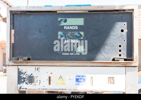 A close up view of the front of a old petrol pump in an abandened garage or station Stock Photo