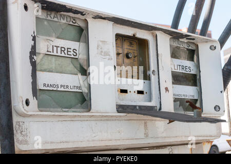 A close up view of the front of a old petrol pump in an abandened garage Stock Photo