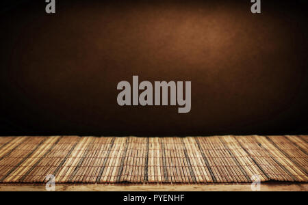 Empty bamboo table and green wall in background. Stock Photo