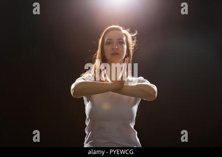 Young woman jazz funk dancer exercising dance moves in studio Stock Photo