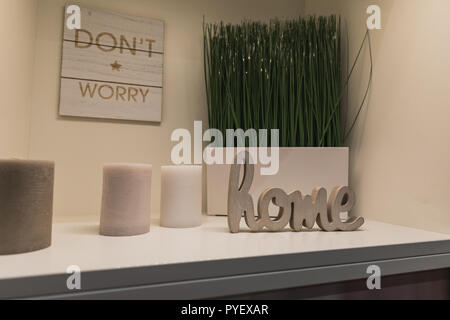 dont worry is written on a sign and wooden characters showing the word, home, candles beside the decoration, switzerland Stock Photo