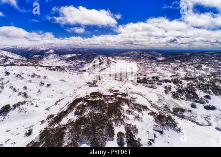 Alpine village Perisher valley in Snowy Mountains of Australia - aerial elevated view with snow covered slopes of popular skiing resort during height  Stock Photo