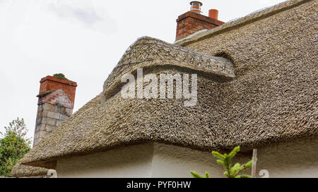 elaborate thatched roof of a cottage  in a Irish village Stock Photo