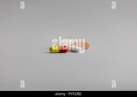 pills in different colors on white background, medicine Stock Photo
