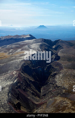 Crater of Mount Tarawera, near Rotorua, and volcanic cone of Putuaki / Mount Edgecumbe in distance, North Island, New Zealand - aerial Stock Photo