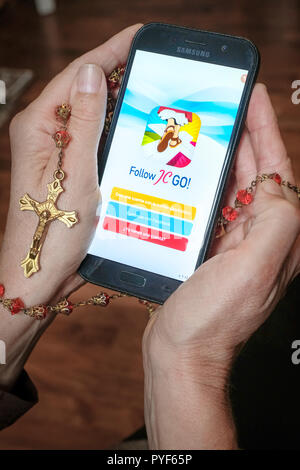 Vatican releases the smartphone app 'Follow JC GO!' (Follow Jesus Christ), which is almost identical to the model Pokémon Go. Instead of monsters, saints are now being sought and catched in the Vatican game. The game is currently only available in Spanish, other language versions will be released shortly. Photo shows login page of 'Follow JC GO!' on a smartphone. Stock Photo