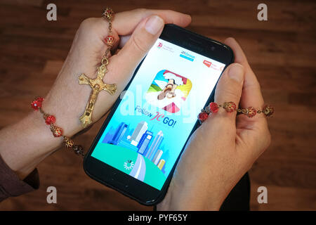 Vatican releases the smartphone app 'Follow JC GO!' (Follow Jesus Christ), which is almost identical to the model Pokémon Go. Instead of monsters, saints are now being sought and catched in the Vatican game. The game is currently only available in Spanish, other language versions will be released shortly. Photo shows login page of 'Follow JC GO!' on a smartphone. Stock Photo