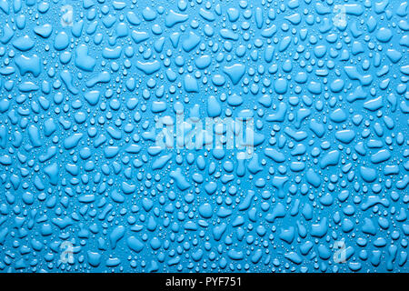 Abstract water drops on the blue background. Stock Photo