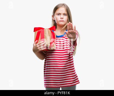 Young beautiful girl giving christmas or valentine gift over isolated background with open hand doing stop sign with serious and confident expression, Stock Photo