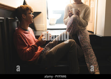 Couple interacting with each other while having coffee Stock Photo