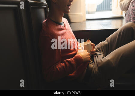Couple interacting with each other while having coffee Stock Photo