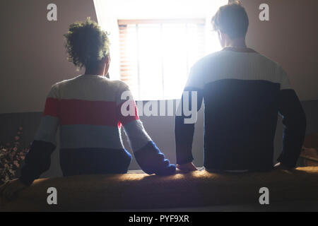 Couple relaxing in bedroom at home Stock Photo